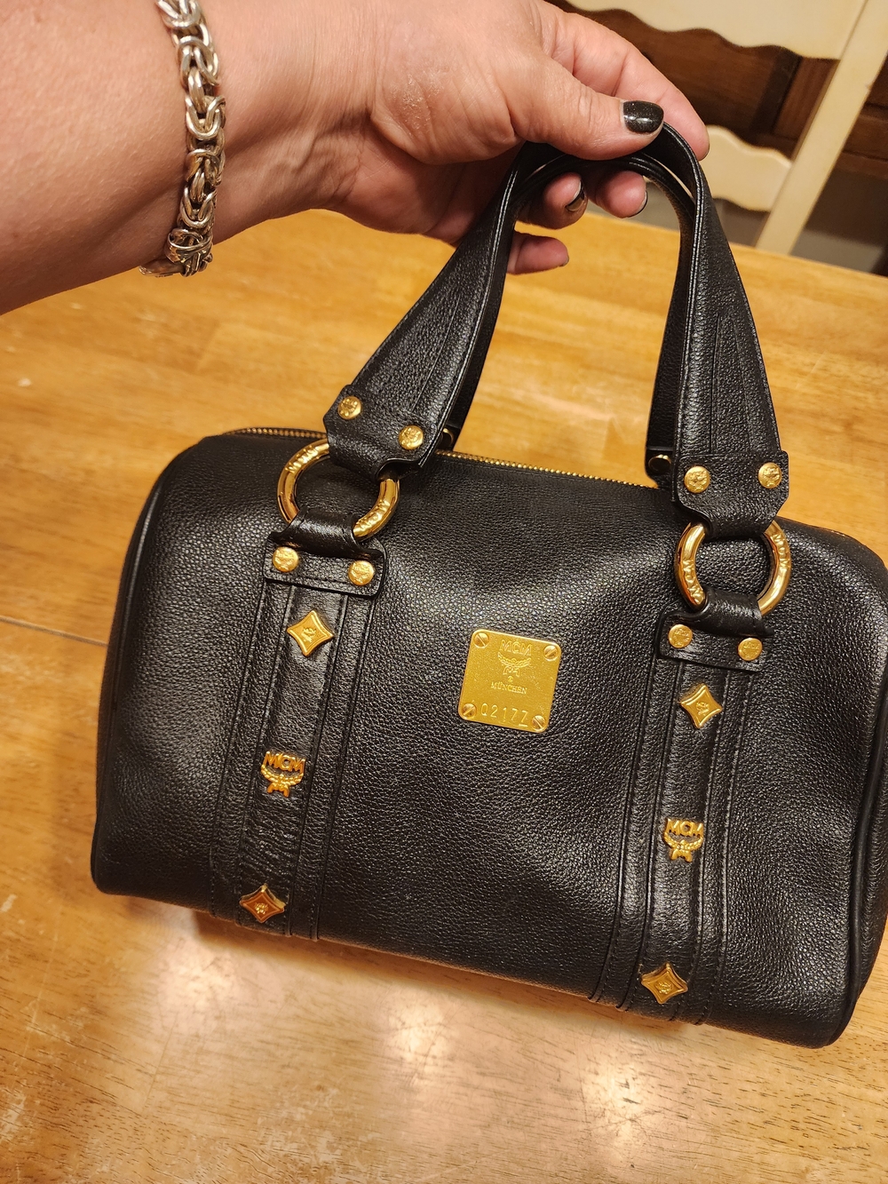 MCM Black Leather Boston Bag featuring polished gold-tone hardware